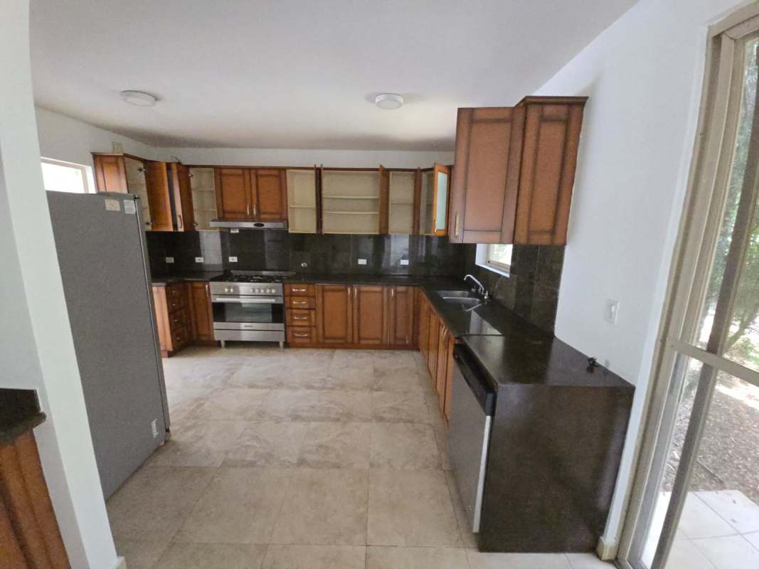 Spacious covered patio area with ceiling fan and fenced backyard in Embassy Gardens Clayton Panama