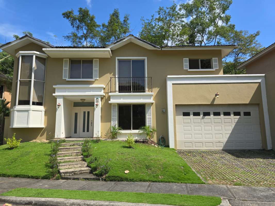 Bright living room with tile floors, AC, and large windows in house Embassy Gardens Clayton