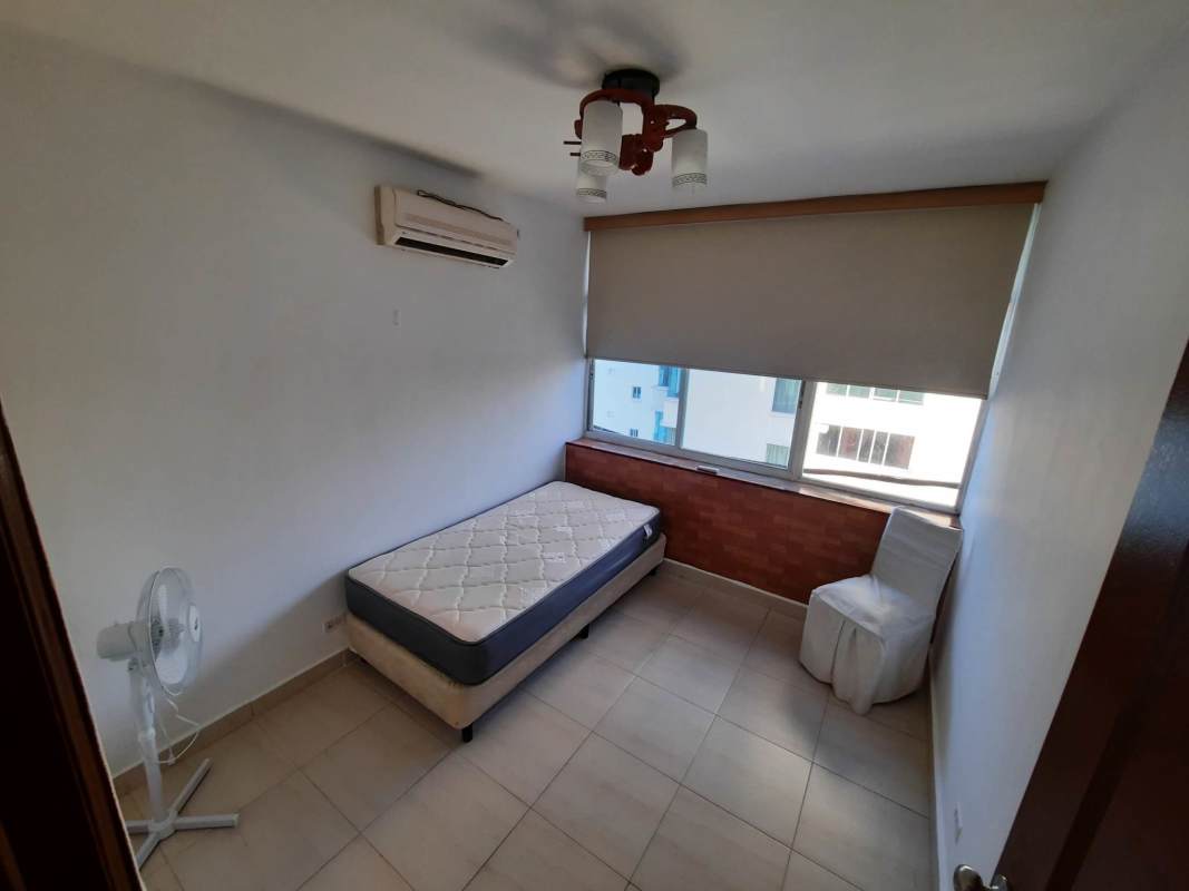 Contemporary kitchen with white cabinets, granite style countertop, gas stove in Edison Park apartment Panama