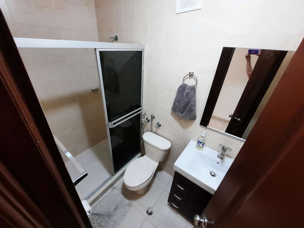 Simple bedroom with single bed, window, AC, in Edison Park Panama apartment for sale