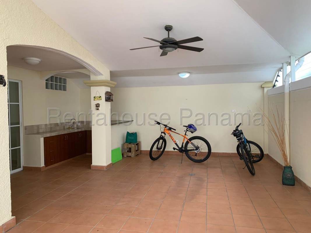 Living room with rattan furniture large windows furnished Panama house Dorado Spring