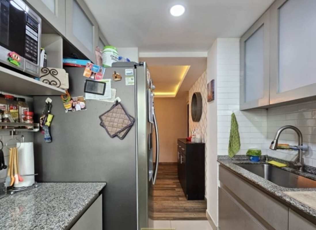 Kitchen with granite counters, appliances and storage Villa de las Fuentes Panama