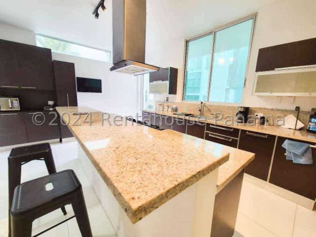 Spacious living area with sectional, recessed lighting, wood floors minimalist house rental Panama