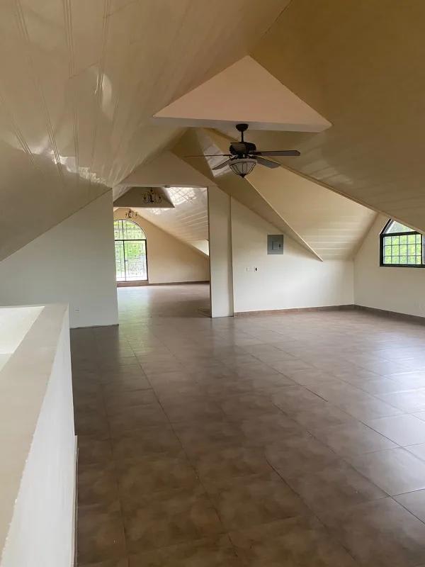 Large traditional living room with chandelier, ornate furniture and tiled floor in Panama City home