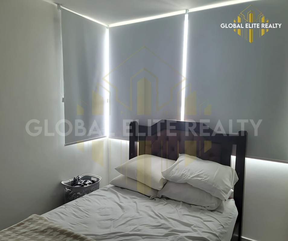 Bright master bedroom with large window panoramic city view Betania apartment Panama City