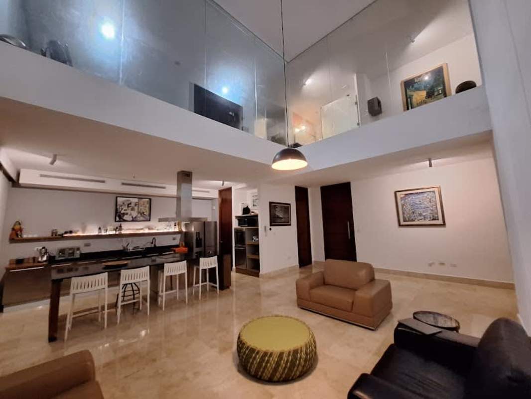 Contemporary loft kitchen with island, built-in appliances, modern lighting in PH Loft 41 Punta Pacifica Panama