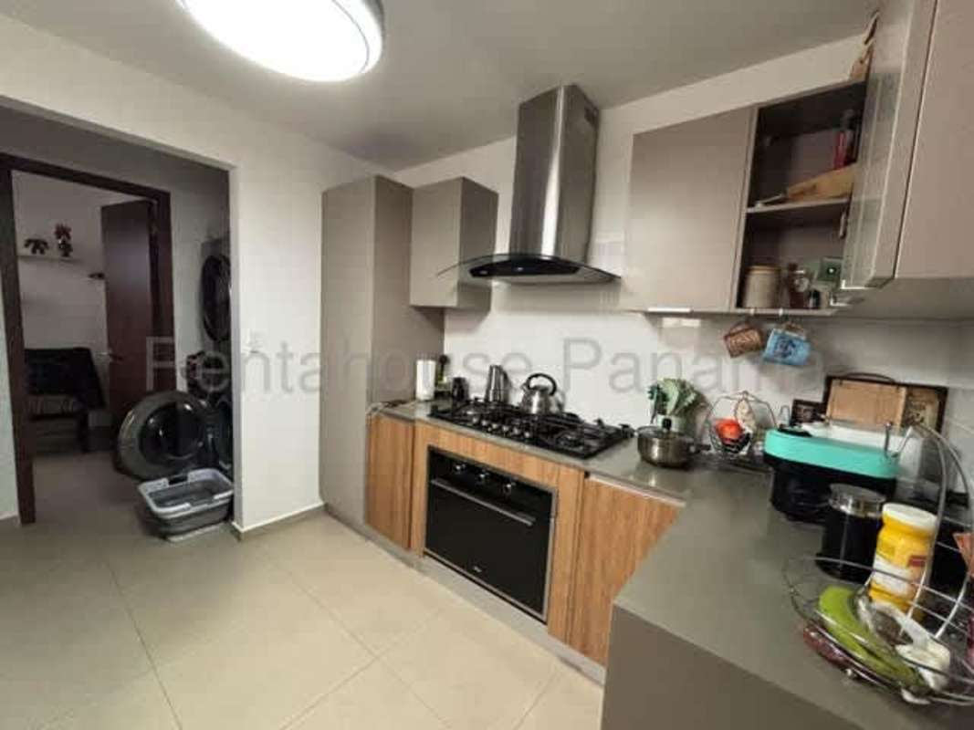 Spacious kitchen with modern cabinetry, appliances space, and natural light in Golf Gardens II house Panama