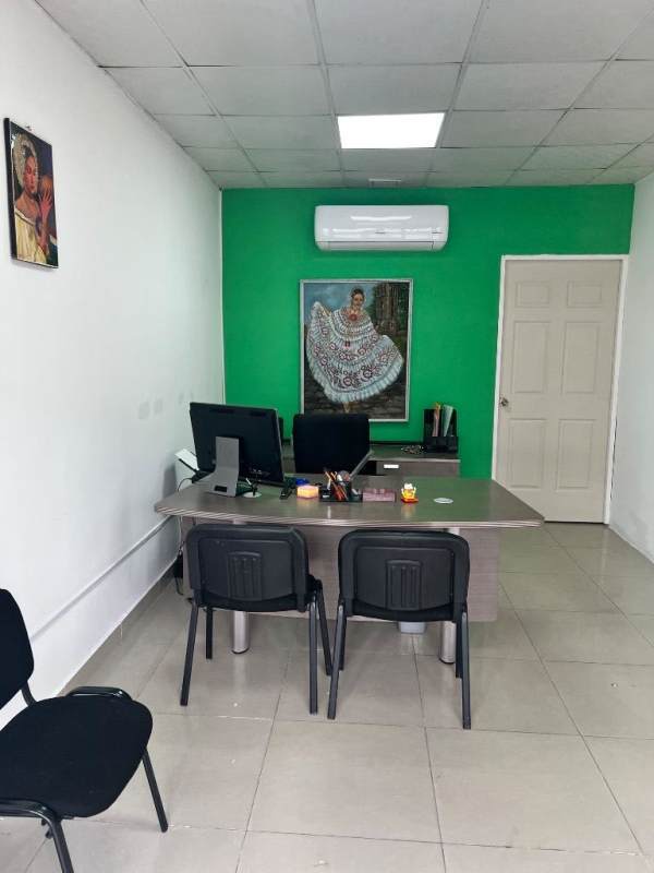 Modern office featuring green accent wall, AC unit, desk and computers in Plaza Feliz San Miguelito Panama