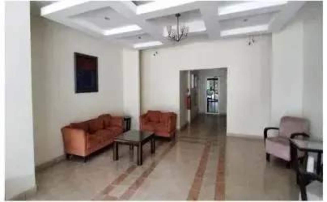 Swimming pool with sun loungers, palm trees, apartment tower Imperial Towers Panama