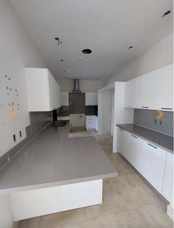 Kitchen with white cabinets, gray countertops, tile flooring, range hood in PH GreenView Santa Maria Panama