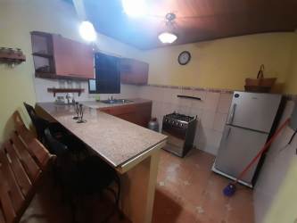 Traditional kitchen with granite breakfast bar wooden ceiling gas stove Nueva Gorgona house for sale