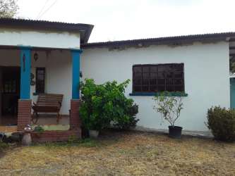 Covered porch swing bench rustic single story house garden Nueva Gorgona Panama