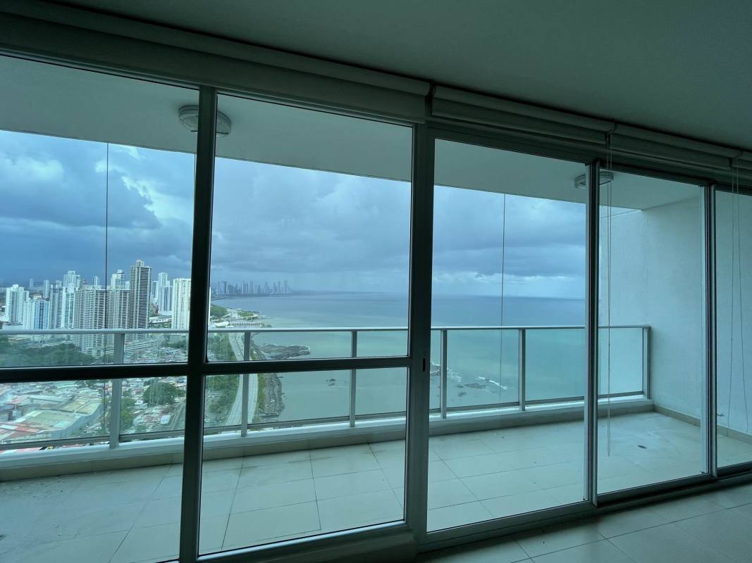 Minimalist open-concept apartment with granite kitchen floor-to-ceiling windows Punta Pacifica Panama