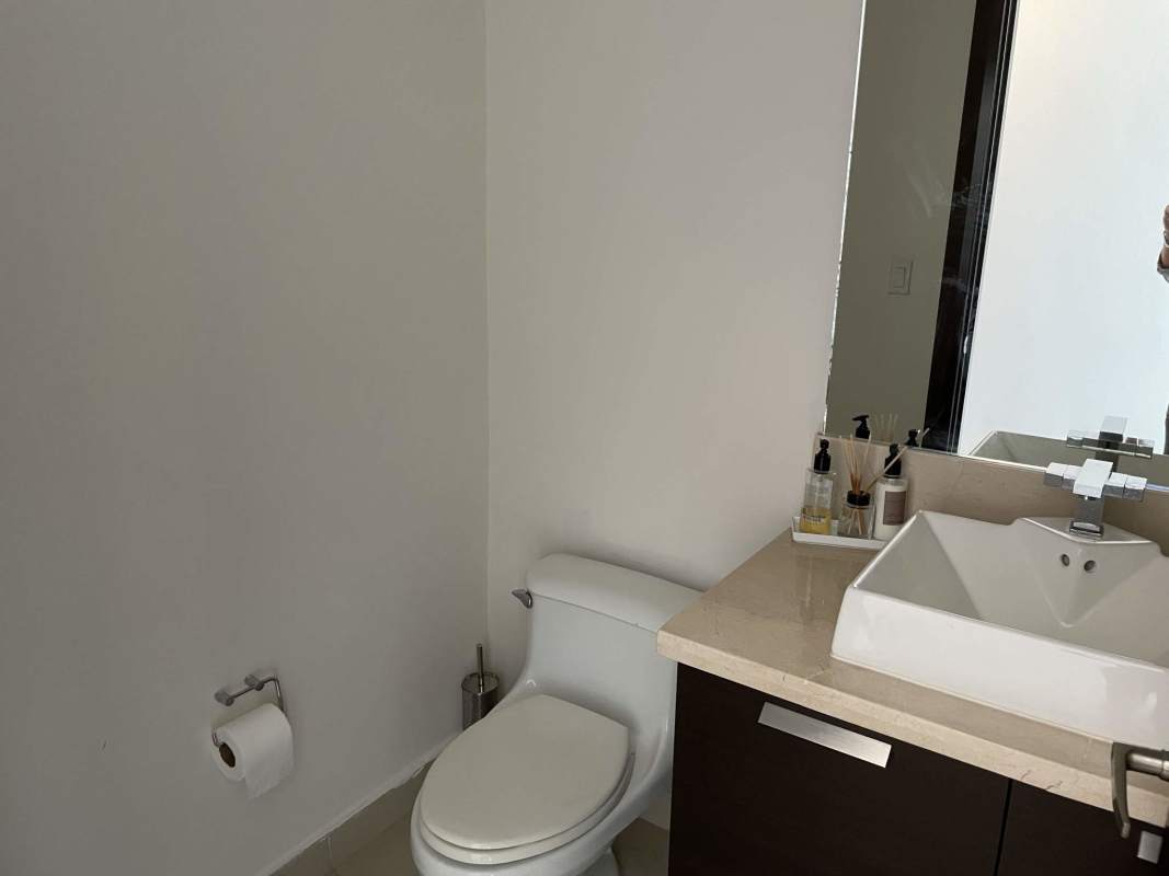 Contemporary bathroom with large mirror beige countertop in luxury apartment Punta Pacifica