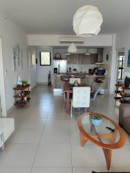 Modern living dining area with panoramic ocean view balcony at PH Punta Caelo Panama