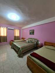 Open plan living dining with colorful wall and kitchen apartment complex El Valle Panama