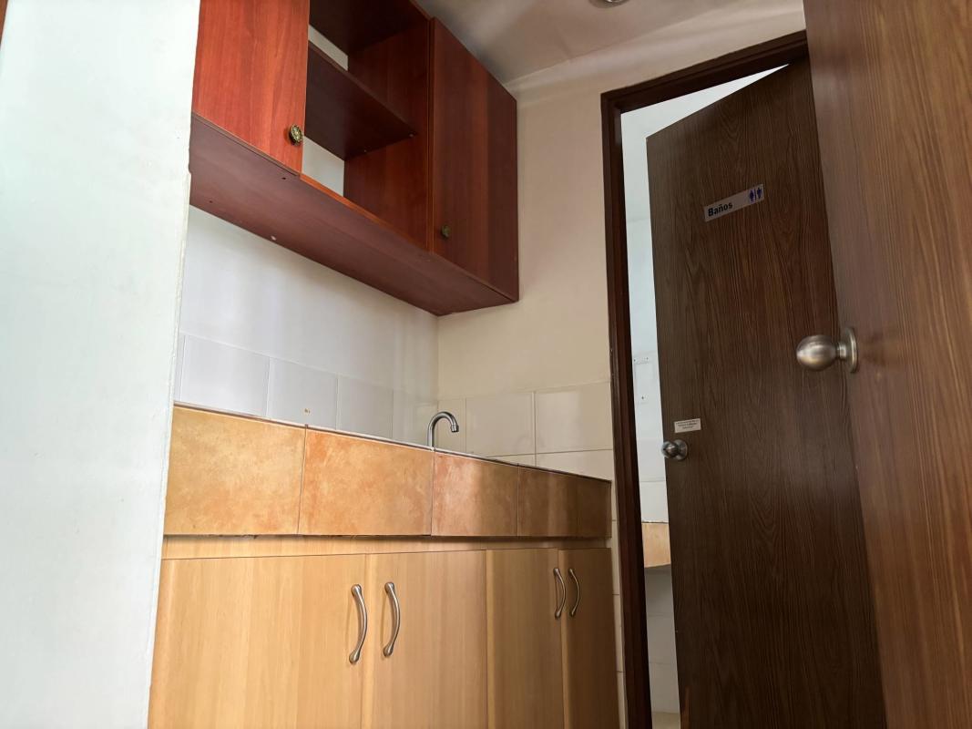 Small office kitchenette with cabinetry sink and restroom entrance City Center Tower Panama