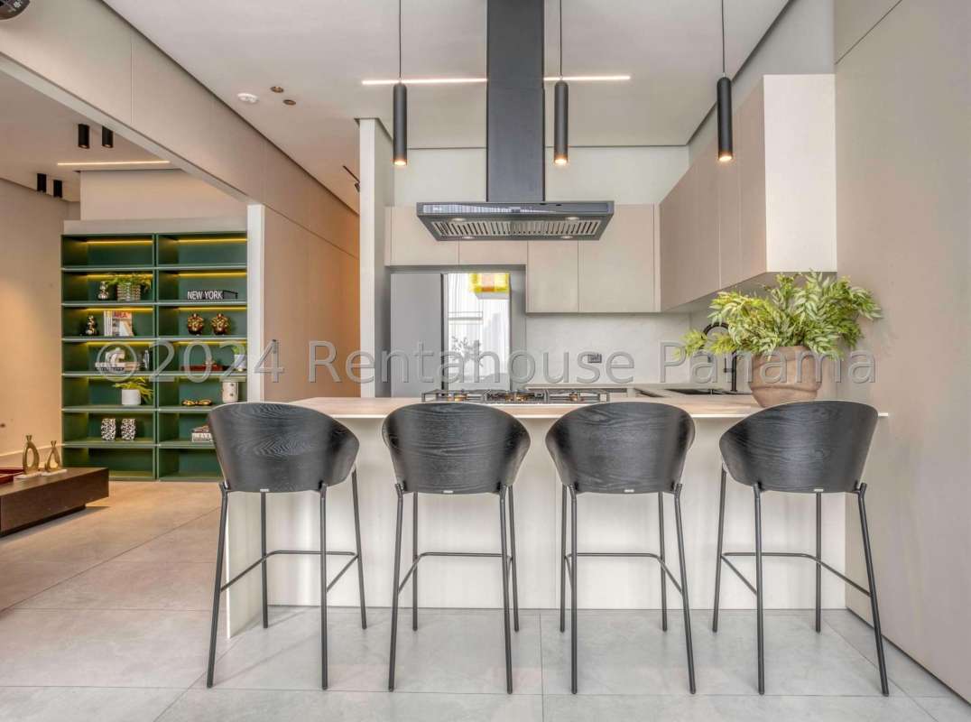 Contemporary kitchen with island, quartz counters, pendant lights in PH Marina Pinnacle Punta Paitilla Panama