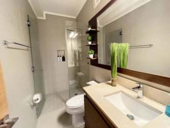 Contemporary bathroom with glass enclosure in luxury beachfront apartment San Carlos