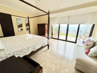 Spacious master suite with ocean view balcony, four-poster bed in Buenaventura Panama