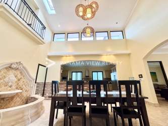Mediterranean-style dining area with high ceilings, chandelier, stone fountain in Buenaventura Panama
