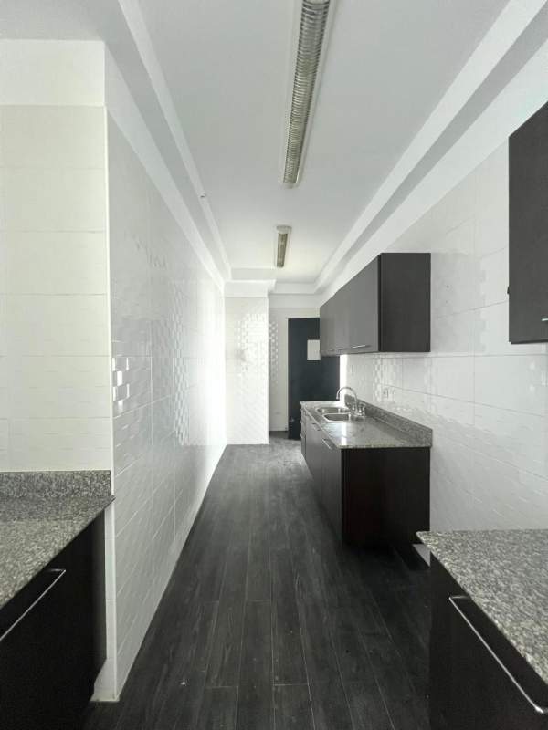 Modern bedroom with floor-to-ceiling windows and built-in closets overlooking Bella Vista Panama