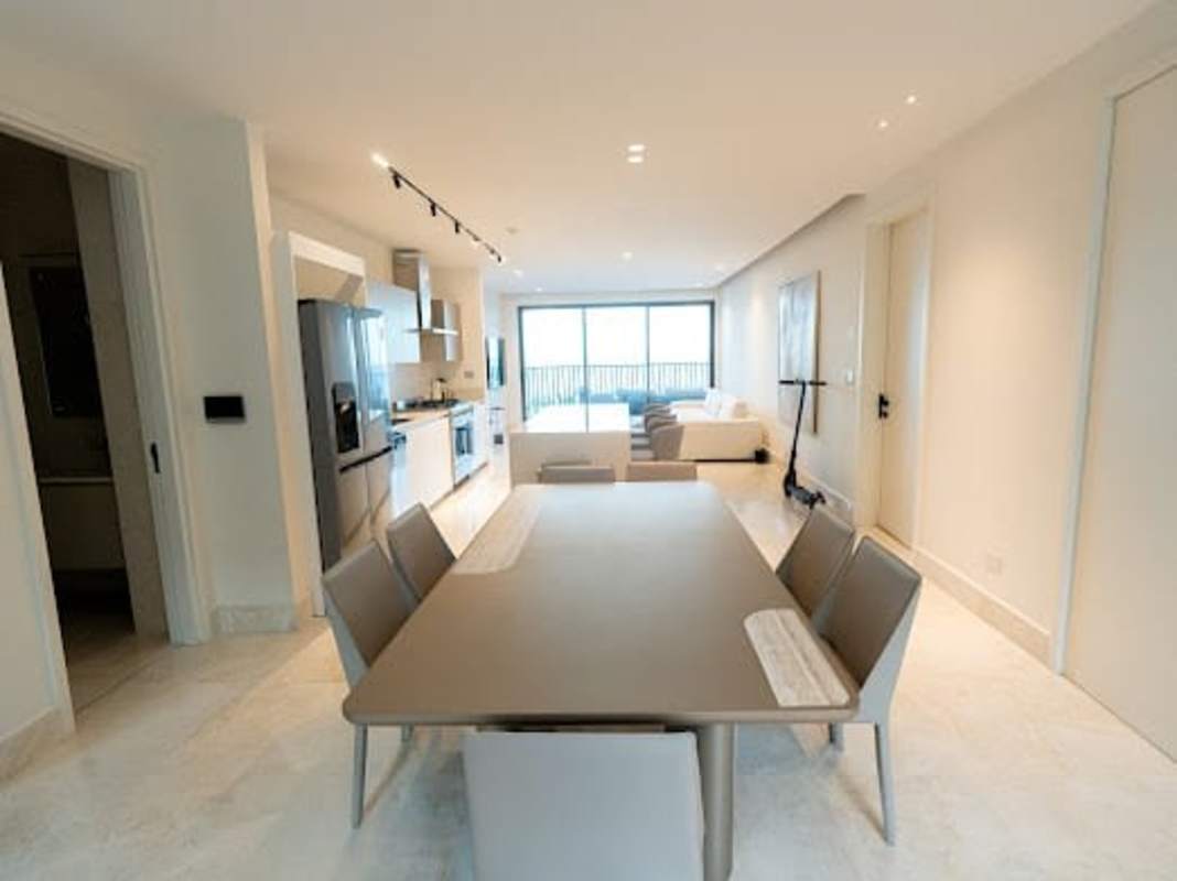 Modern open living-dining area with large sliding doors, balcony access and minimalist design Seascape Ocean Reef Panama City