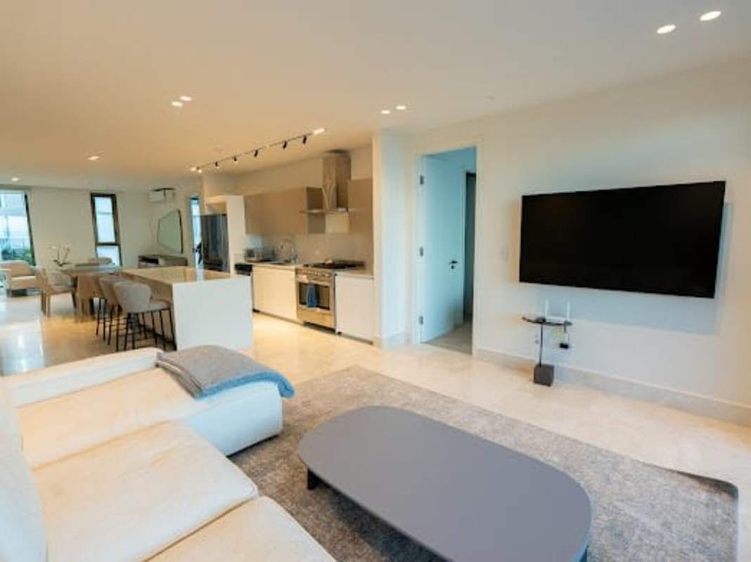 Modern living room with ocean views, neutral decor and balcony doors in Seascape Ocean Reef Islands Panama