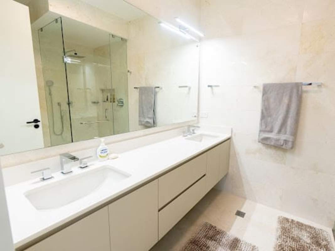 Large private terrace with wicker furniture overlooking Pacific Ocean and pool at Seascape Ocean Reef Panama