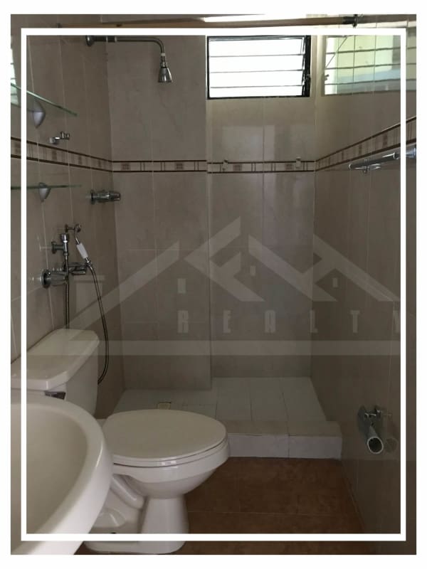 Modern bathroom with walk-in shower and beige tiles in Villa de las Fuentes Panama
