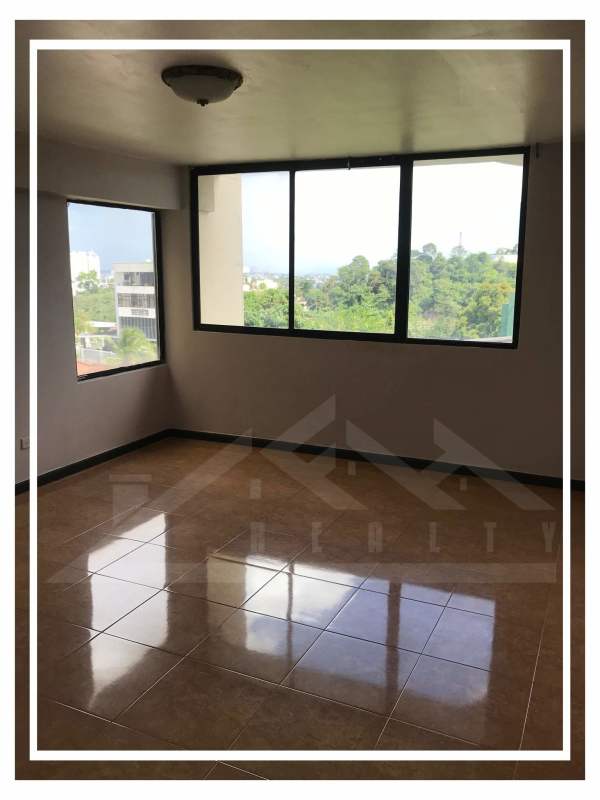 Open concept living and dining area with large windows and tile floors Villa de las Fuentes Panama City