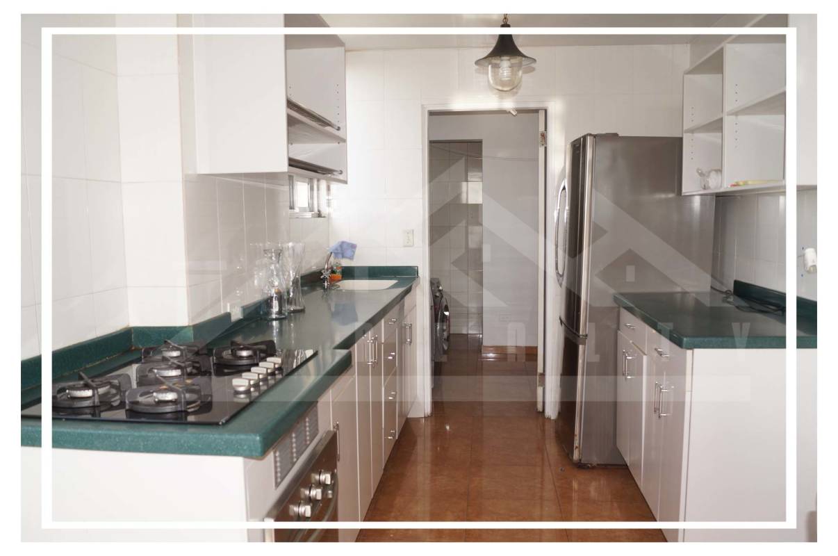 Close up modern kitchen with fridge, gas stove, cabinets in Villa de las Fuentes Panama