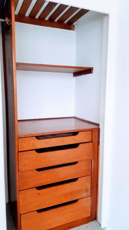 Original vintage kitchen with double sink, yellow backsplash, and white cabinets in El Carmen Panama