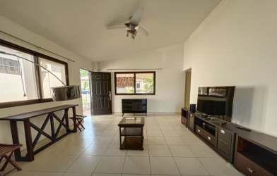 Kitchen with L-shaped counters, tile backsplash and large window in house PH Summer Hills Costa Verde Panama