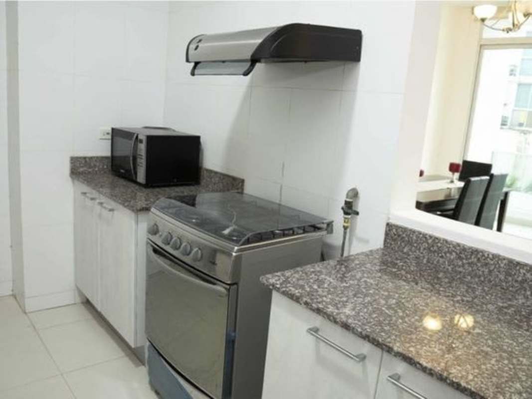 Full kitchen with granite countertops and stainless appliances in furnished rental Panama