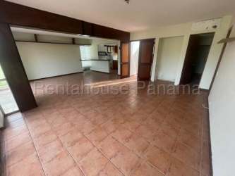 Kitchen with wood cabinets and breakfast bar inside Villas Decameron Residential Coclé Panama