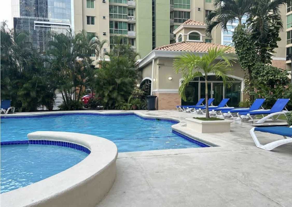 Swimming pool area with lounge chairs and greenery PH Green Bay Costa del Este Panama City