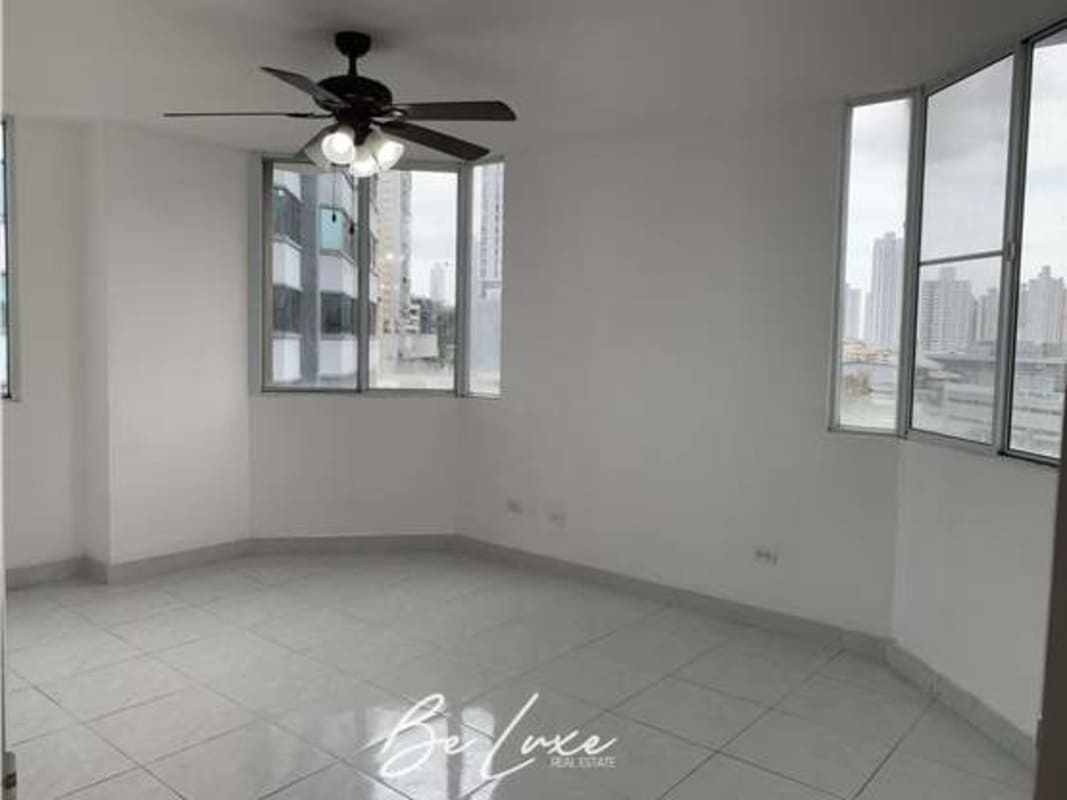 Bright kitchen with L-shaped white cabinetry, double stainless sink, tiled backsplash in PH Brisas de San Fernando