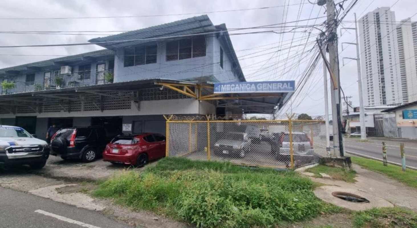 Two-story commercial property front with signage parking lot fenced in Parque Lefevre Panama