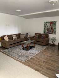 Spacious living room with sofa and decor in Valle Dorado house La Chorrera Panama