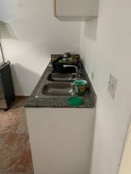 Kitchen with granite counters and dual sink in affordable La Chorrera house Panama