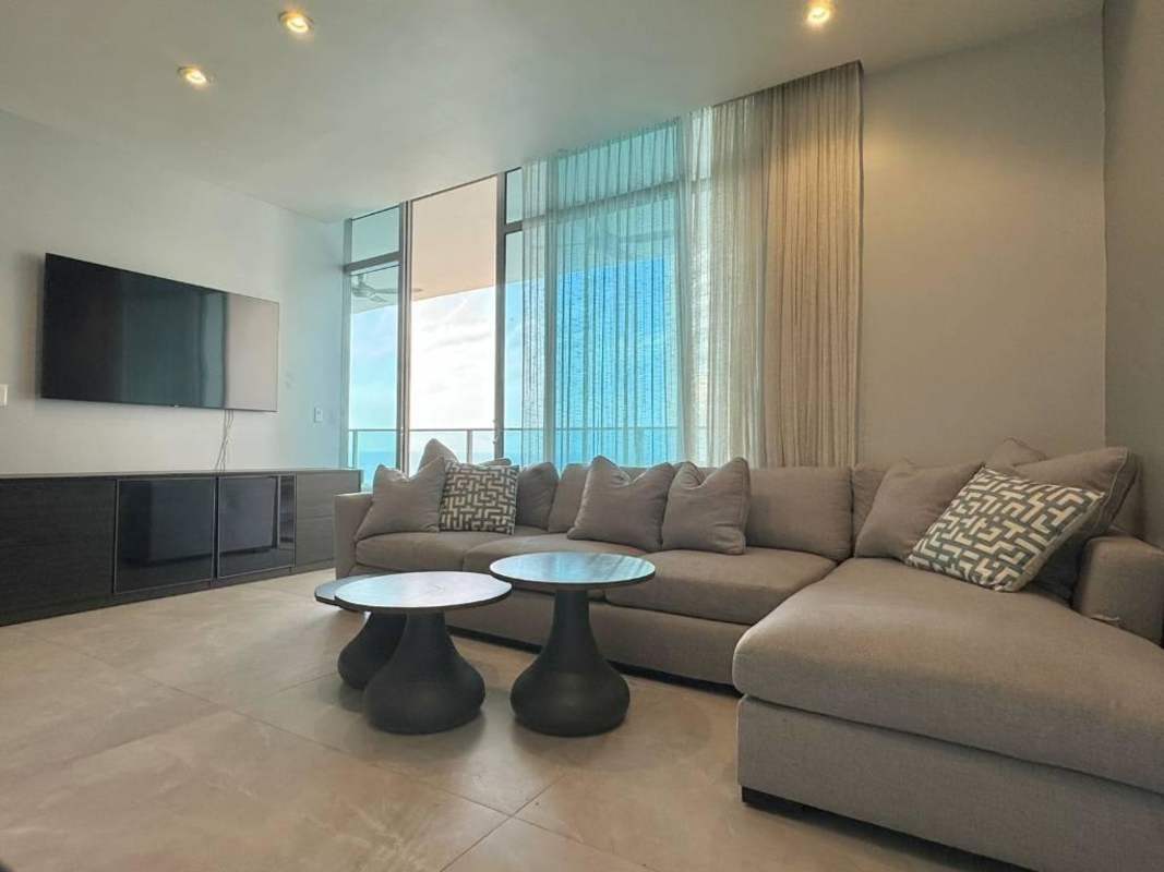 Modern bedroom with large windows and city skyline view at PH Grand Tower Punta Pacífica Panama