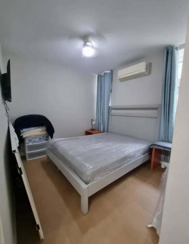 Cozy furnished bedroom with air conditioning, closet, wood floors at PH Vista Argentina El Cangrejo Panama City