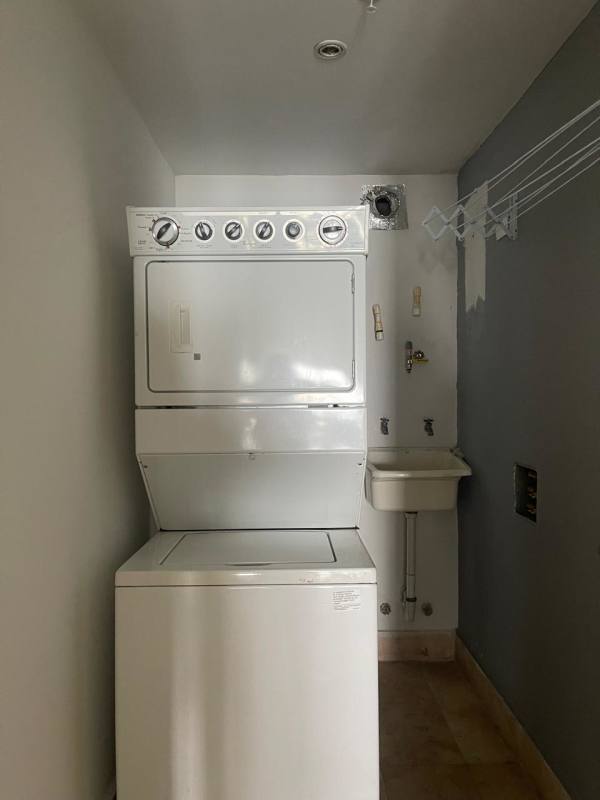 Bedroom with ocean view window, bright natural light, modern minimalist style in YOO Panama Condo