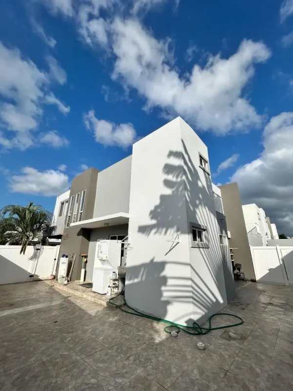 Two-story corner house with driveway and fence in PH Augusta Brisas del Golf suburban setting