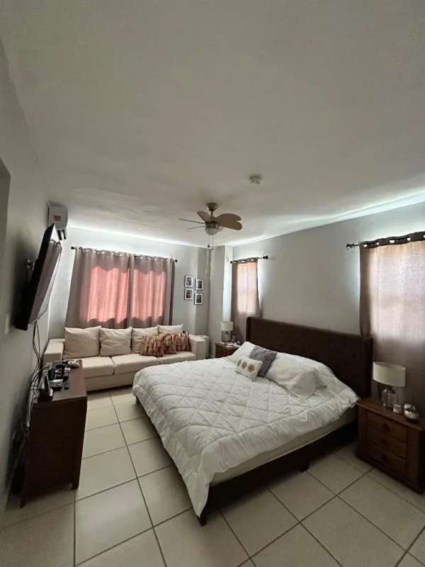 Spacious master bedroom with king bed, sofa, ceiling fan in PH Augusta Panama City