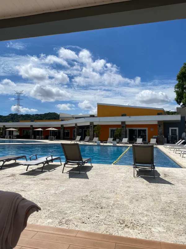 Outdoor swimming pool and social areas with mountain background PH Augusta Brisas del Golf