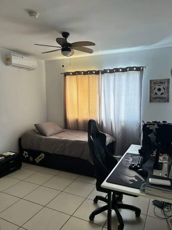 Simple bedroom with work desk, ceiling fan, tile flooring at PH Augusta Brisas del Golf Panama City