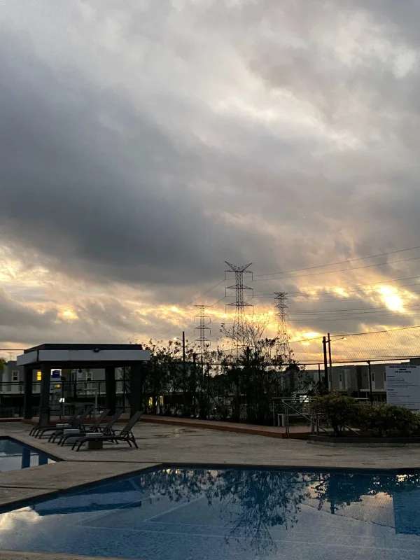Modern outdoor swimming pool with lounge chairs and pergola at PH Augusta Brisas del Golf