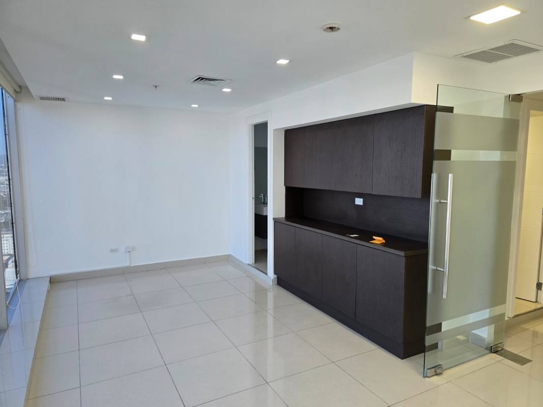 Modern commercial office with glass partition doors and tiled floors at PH Oceania Business Plaza in Punta Pacifica Panama City